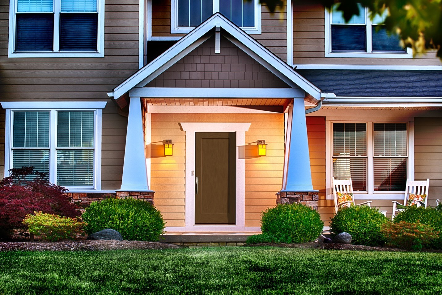 Home with tan vinyl siding and an energy efficient front door Home with tan vinyl siding and an energy efficient front door