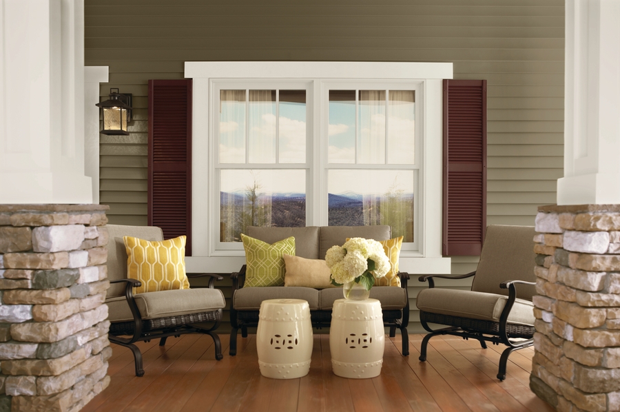 Outdoor seating in front of double-hung windows on a porch Outdoor seating in front of double-hung windows on a porch