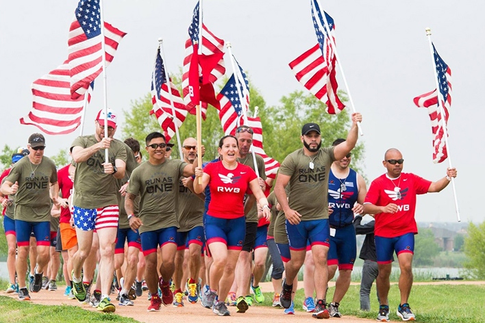 Smiling people carry the American flag for a good cause Smiling people carry the American flag for a good cause