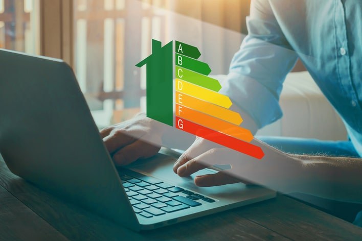 Person on a laptop at home investigating energy efficient home improvement credit with Window World
